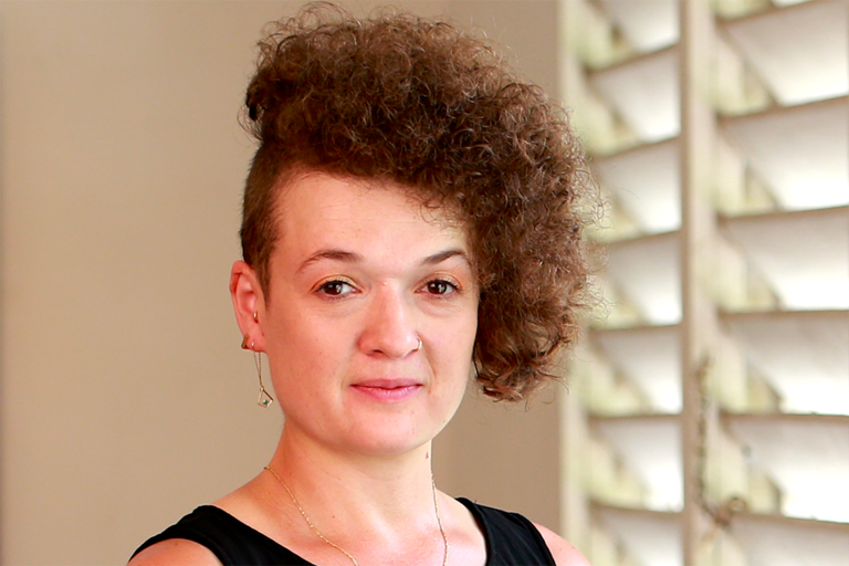 A portrait of Timmia Hearn DeRoy standing next to a window.