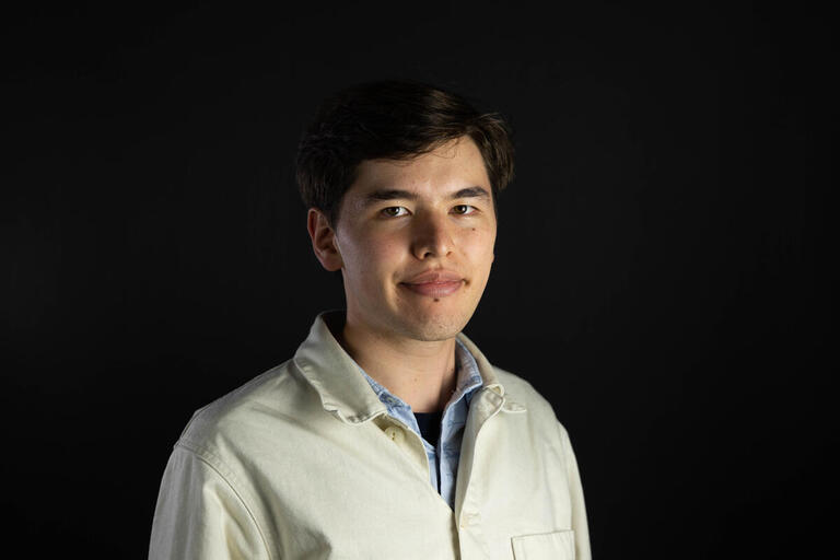 A headshot of Wilhelm Scholz wearing a yellow button down. 